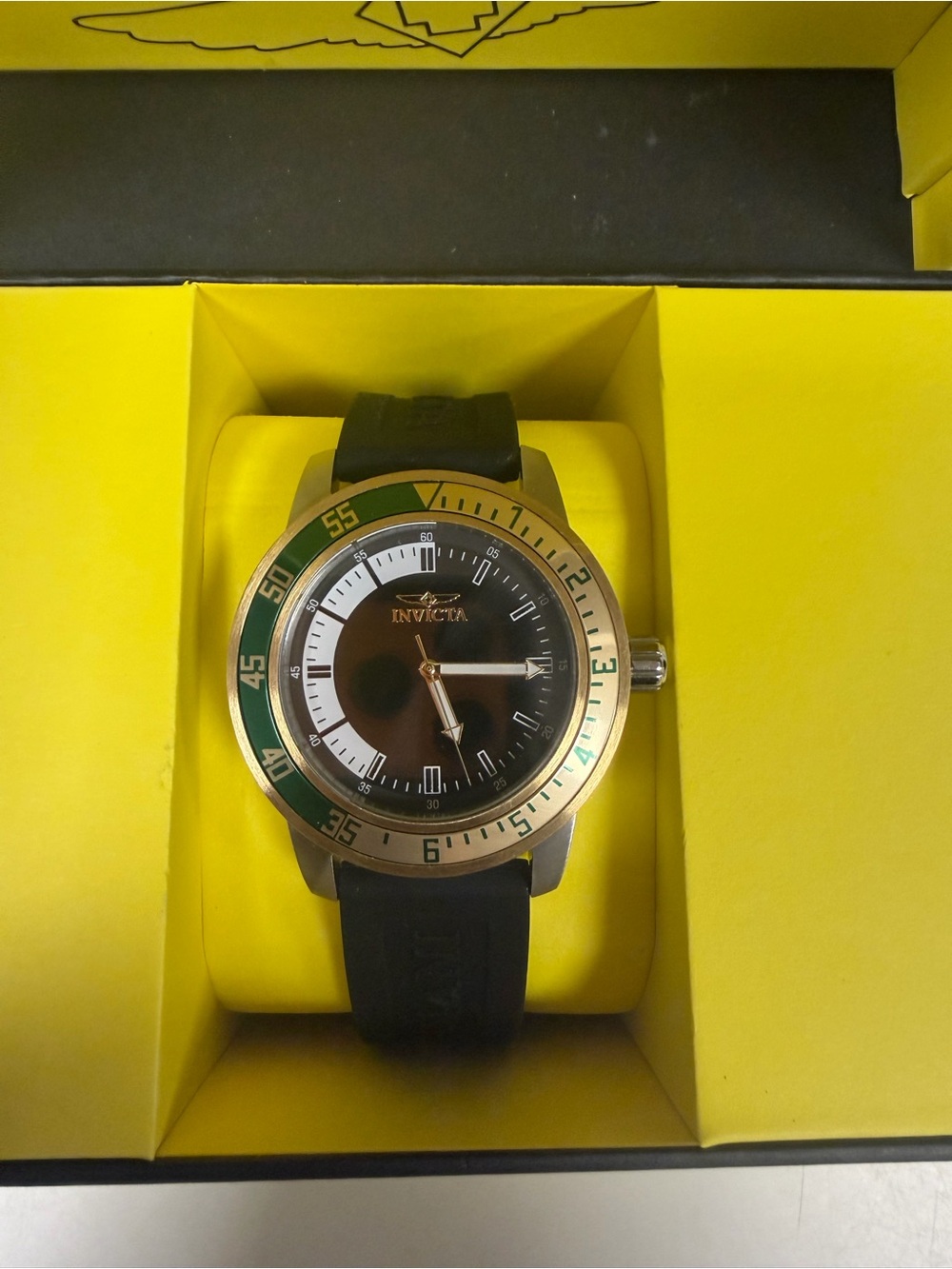 Invicta Black Dial Watch with Gold Case and Green Bezel